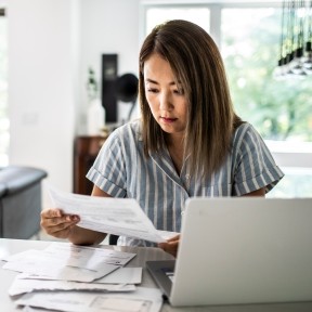 Woman reviewing bank statements.